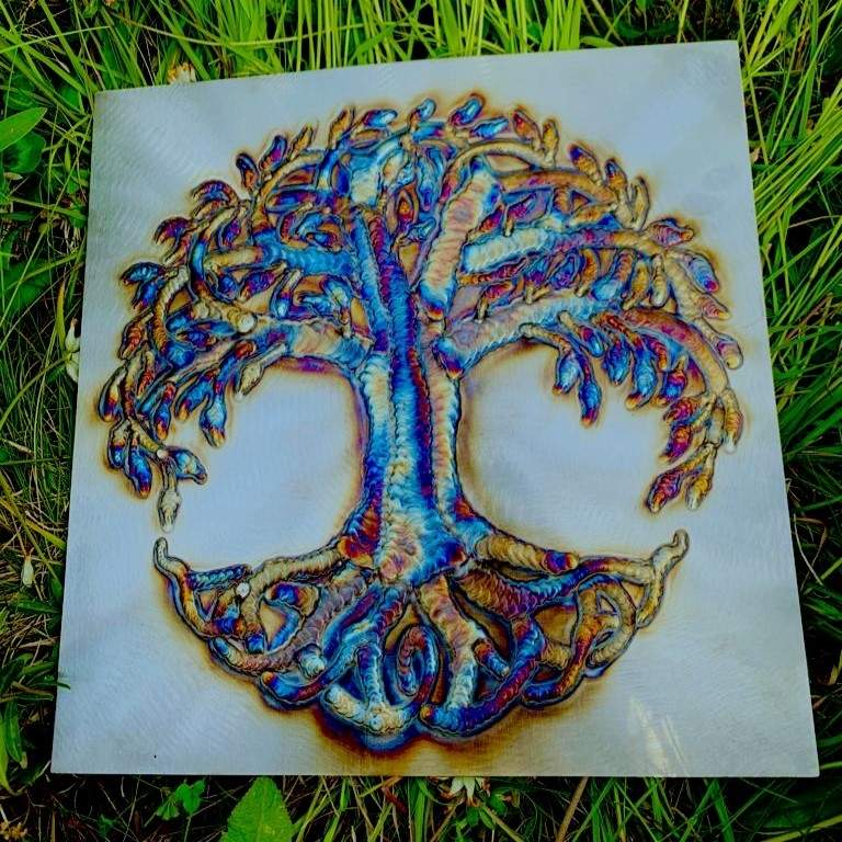 Colorful welded metal Tree of Life wall artwork on stainless steel with rainbow heat effects